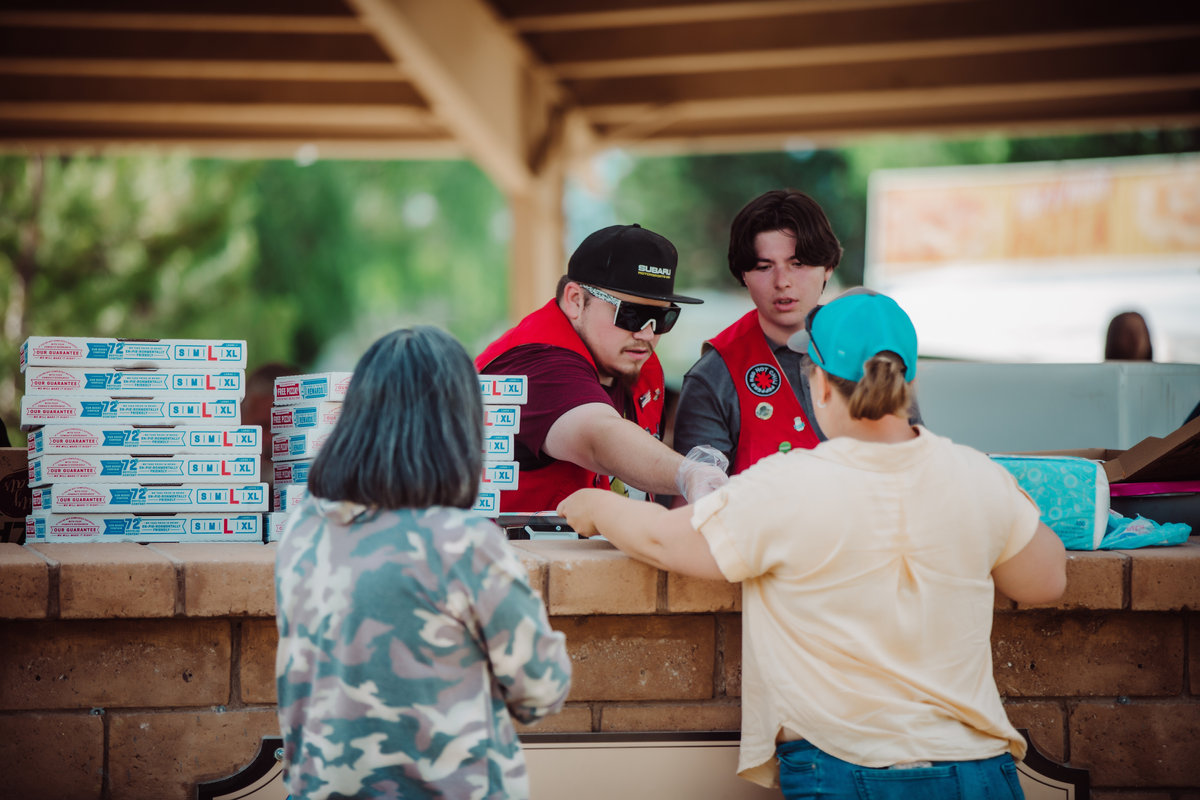 Two Carson Valley Active 20-30 volunteers serving food at a park